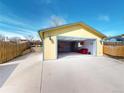 Detached garage with open door, lighting, workbench, and storage cabinets and a red sofa at 4487 S Alkire St, Morrison, CO 80465