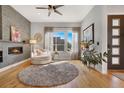 Bright living room with a fireplace and hardwood floors at 4937 Tamarac St, Denver, CO 80238