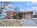 Charming two-story brick home with attached garage and mature trees at 6047 Vivian Ct, Arvada, CO 80004