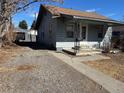 Exterior view of the home with a driveway and access to a detached garage at 2915 W 4Th Ave, Denver, CO 80219