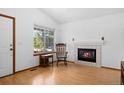 Cozy living room with a fireplace and large window overlooking the yard at 8761 Cloverleaf Cir, Parker, CO 80134