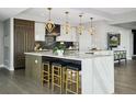 Gourmet kitchen with quartz countertops, custom cabinetry, and a large center island at 2001 Lincoln St # 2923, Denver, CO 80202