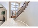 Bright foyer features tile floor, open staircase, and a soaring two-story window at 1007 Thorncreek Ct, Thornton, CO 80241