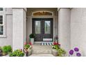 Elegant entryway with a double front door, potted plants and tiled floor at 9468 E Aspen Hill Ln, Lone Tree, CO 80124