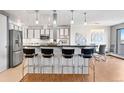 Bright kitchen boasts white cabinets, stainless steel appliances, and a convenient breakfast bar at 3131 E Alameda Ave # 803, Denver, CO 80209