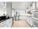 Well-equipped kitchen features stainless steel appliances and sleek white cabinets with modern hardware at 3131 E Alameda Ave # 803, Denver, CO 80209