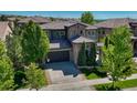Attractive two-story home with stone accents, a basketball hoop, and mature landscaping at 15235 W Iliff Ave, Lakewood, CO 80228