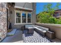 Cozy outdoor patio with comfortable seating, a fire pit, and a stylish black and white patterned rug at 15235 W Iliff Ave, Lakewood, CO 80228