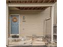 Charming townhouse entrance with a welcoming blue door, decorative wreath, and wooden steps at 1661 S Fulton St, Aurora, CO 80247