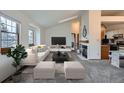 Bright living room with large windows, neutral tones, and a modern fireplace, creating a cozy space at 1661 S Fulton St, Aurora, CO 80247