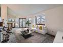 Bright and spacious living room with a cozy fireplace and abundant natural light from large windows and a sliding glass door at 1661 S Fulton St, Aurora, CO 80247