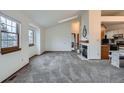Clean, neutral living room featuring natural light, a cozy fireplace, and an open layout at 1661 S Fulton St, Aurora, CO 80247