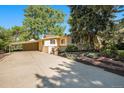 Charming single-story home with mature trees and a long driveway, perfect for suburban living at 895 Vance St, Lakewood, CO 80214