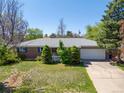 Beautiful single-story home with manicured front yard and attached two-car garage with long driveway at 430 S Potomac Cir, Aurora, CO 80012