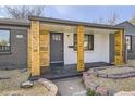 Inviting front porch with wood accents and a well-maintained entrance providing a warm welcome at 6105 Lamar St, Arvada, CO 80003