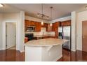 Modern kitchen with stainless steel appliances, ample counter space, and warm wood cabinetry at 13456 Via Varra # 208, Broomfield, CO 80020