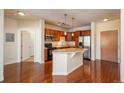 Well-equipped kitchen with stainless steel appliances, a breakfast bar, and wood cabinets at 13456 Via Varra # 208, Broomfield, CO 80020