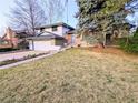 Exterior view of home with a manicured lawn and garden, offering a welcoming appeal at 3326 S Geneva St, Denver, CO 80231