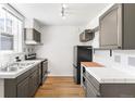 Functional kitchen with tile countertops, stainless steel appliances, and bright natural light at 215 E 11Th Ave # D5, Denver, CO 80203