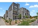 Modern homes with gray siding, stone accents, and well-kept landscaping at 20999 E Quincy Dr, Aurora, CO 80015