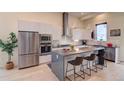 Modern kitchen boasts stainless steel appliances, marble backsplash, and a spacious gray waterfall island at 5125 W 29Th Ave # 1, Denver, CO 80212