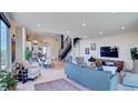 Spacious living area featuring hardwood floors, modern lighting, and stylish furnishings at 5125 W 29Th Ave # 1, Denver, CO 80212