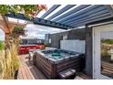 Rooftop deck boasts hot tub, bar area, and pergola, ideal for outdoor entertaining and relaxation at 5125 W 29Th Ave # 1, Denver, CO 80212