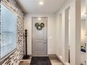 The entryway features luxury vinyl plank floors and stone accent wall at 6883 E 132Nd Pl, Thornton, CO 80602