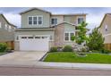 Charming two-story home features a two-car garage and well-manicured lawn at 6883 E 132Nd Pl, Thornton, CO 80602