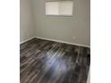 Neutral bedroom with hardwood floors and natural light from the window at 9041 Lilly Ct, Thornton, CO 80229