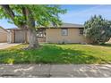 Charming home featuring a well-maintained lawn, mature trees, and a single-car garage at 741 S 6Th Ave, Brighton, CO 80601