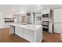 Modern kitchen featuring stainless steel appliances, a large island, and fireplace view at 741 S 6Th Ave, Brighton, CO 80601