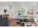 Bright living room featuring high ceilings, a large sectional sofa, and hardwood floors at 728 Poppywood Pl, Highlands Ranch, CO 80126