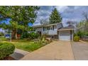 Inviting home featuring a lush green lawn, mature trees, and a convenient attached garage at 790 Mohawk Dr, Boulder, CO 80303