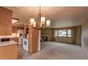 Open-concept kitchen and living room featuring neutral tones, a bright window, and wood cabinets at 790 Mohawk Dr, Boulder, CO 80303