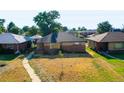 Brick ranch home with a large yard, viewed from above at 3667 N Monaco St, Denver, CO 80207