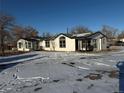 Front view of a remodeled mobile home on a snowy lot at 7070 Henry St, Fort Lupton, CO 80621