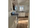 Well-lit kitchen featuring stainless steel appliances, white cabinets, and a modern design at 7070 Henry St, Fort Lupton, CO 80621