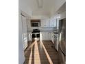 Bright kitchen with stainless steel appliances, white cabinets, and modern countertops at 7070 Henry St, Fort Lupton, CO 80621