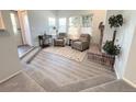 Bright and airy living room with fireplace, lots of windows and neutral decor at 4760 S Wadsworth Blvd # F105, Littleton, CO 80123