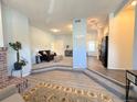 Open-concept living space with stylish flooring, fireplace, and access to the kitchen at 4760 S Wadsworth Blvd # F105, Littleton, CO 80123