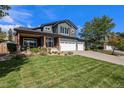 Beautiful two-story home featuring a covered porch and a spacious front yard at 6123 Dunraven Rd, Golden, CO 80403