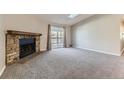 Bright living room features a fireplace, sliding glass doors, and neutral carpeting at 18043 E Ohio Ave # 202, Aurora, CO 80017