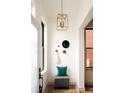 Inviting entryway with herringbone flooring, stylish decor, and ample natural light at 2751 Curtis St, Denver, CO 80205