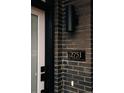 Close-up of the house number '2751 Curtis St' on a brick exterior with modern lighting at 2751 Curtis St, Denver, CO 80205