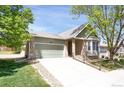 Single-story home with a brick and siding exterior, a two-car garage, and a well-manicured lawn at 8951 Greenwich St, Highlands Ranch, CO 80130