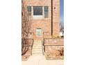 Well-maintained brick townhouse exterior with concrete steps leading to the entrance exudes a classic appeal at 2397 E Iliff Ave, Denver, CO 80210