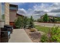 Landscaped front yard featuring decorative stone and mature plantings at 10906 Touchstone Loop, Parker, CO 80134