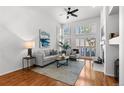 Bright living room boasts a fireplace, hardwood floors, and lots of natural light at 9491 Southern Hills Cir, Lone Tree, CO 80124
