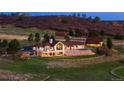 A beautifully landscaped home with a large back patio area and a stone retaining wall at 6330 Old Orchard Ln, Sedalia, CO 80135
